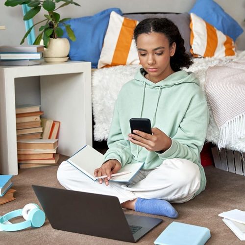 Teen girl doing homework on her laptop